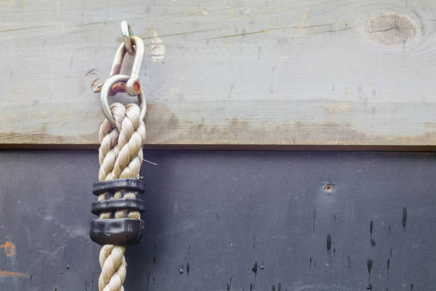 white thick rope with a knot on a brown background device in a metal hook