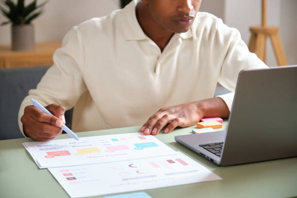 istock Focused young businessman analyzing marketing data and working on business strategy at home office 2177820009