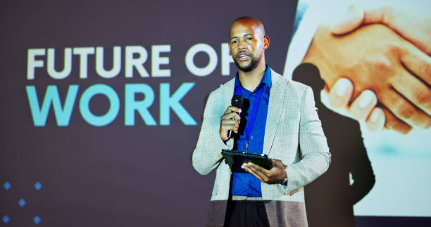istock Screen, speaker and black man at seminar on business transformation, growth and development ideas. Technology, change and presenter at future of work conference with discussion, planning and progress 2177824590