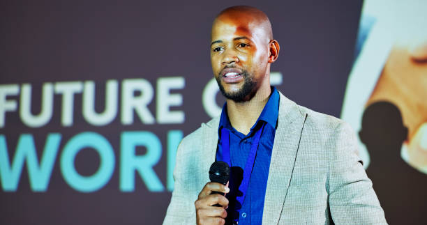 istock Stage, speaker and black man at seminar on business transformation, growth and development ideas. Tech, social change and presenter at future of work conference with discussion, planning and progress 2177824603
