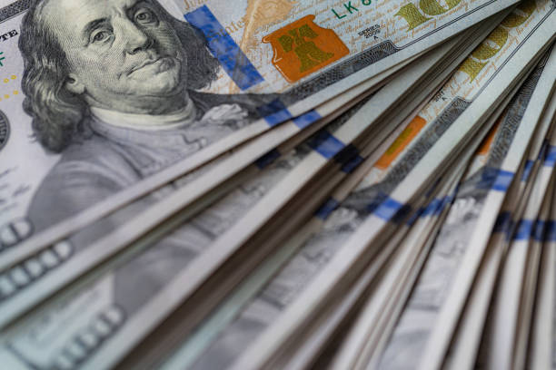 istock Pile of US 100 dollar banknotes on dollars background 2177824776