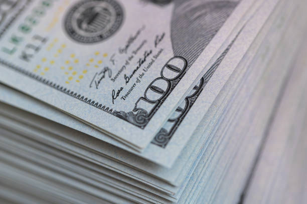istock Pile of US 100 dollar banknotes on dollars background 2177824831