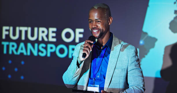 istock Black man, tablet and speech for seminar for sustainability in transportation industry with microphone. Presentation, smile and tech for conference event or business development in future of mobility 2177825054