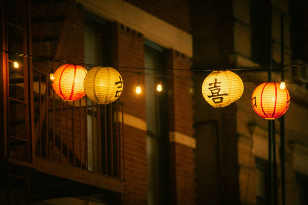 Hanging lanterns glow over Doyers Street in Chinatown, NYC
