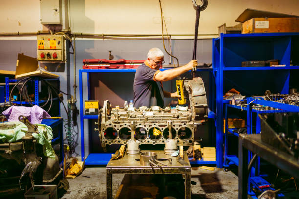 istock Auto mechanic working on a large engine in a garage. Repair service. 2177826463