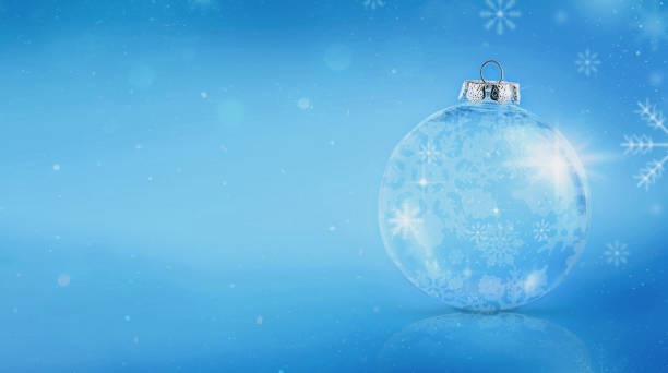 istock Glass sparkling ball with snowflake pattern stands on blue background. Copy space 2177828141