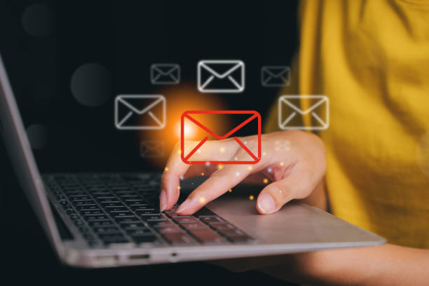 istock Person working on a laptop with email notifications glowing in the background. 2177830777