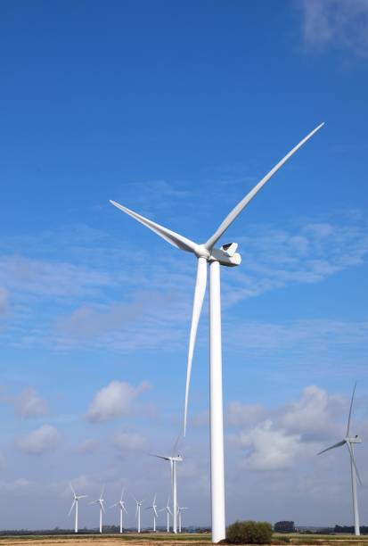 istock wind turbine with three blades rotating using wind power to produce electricity with zero environmental impact anc blue sky 2177831345