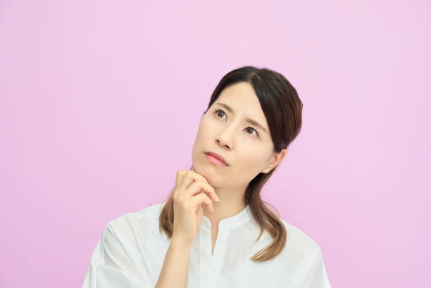 istock A young woman looking up and thinking 2177834019