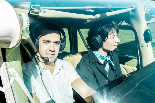 controls in a cockpit and hands of pilot on the steering wheel