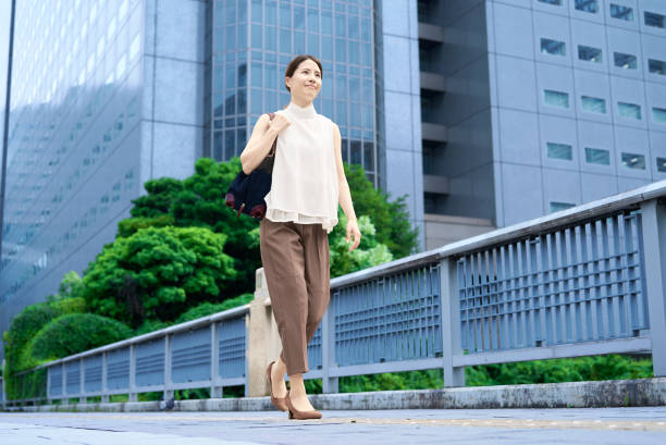 A woman with casual clothes commuting in a business district