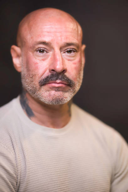Tough-looking man of 48 wearing cream.