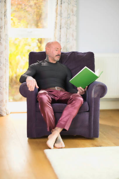 istock Middle aged man relaxing at home with a book 2177835822