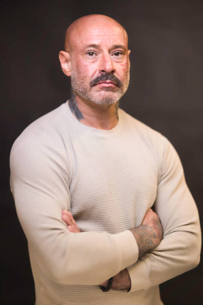 Tough-looking man of 48 wearing cream.