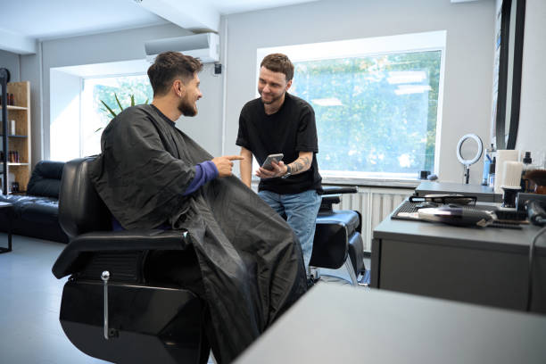 istock Professional barber listens haircut preferences during consultation 2177842636