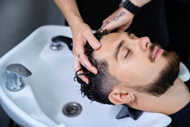 istock Expert groomer cleanses client hair, prepping for precise styling session 2177842707