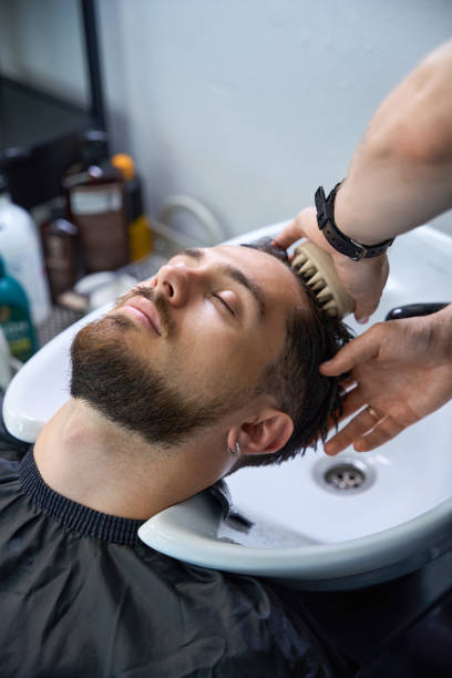 istock Professional stylist cleans hair, setting up for fresh style 2177842723