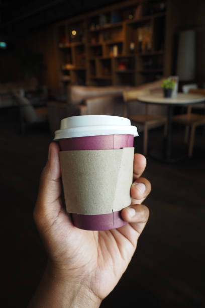 istock pov holding a Blank take away kraft coffee 2177844081