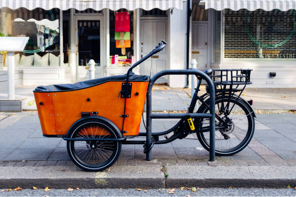 istock Orange cargo bike parked on a london sidewalk 2177844323