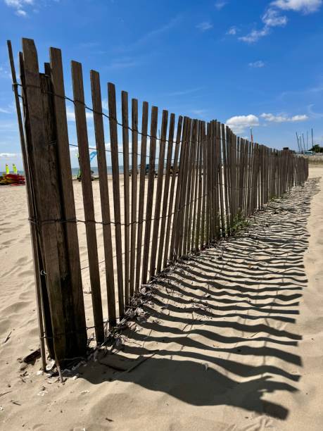 istock wooden fence on a beach 2177847407