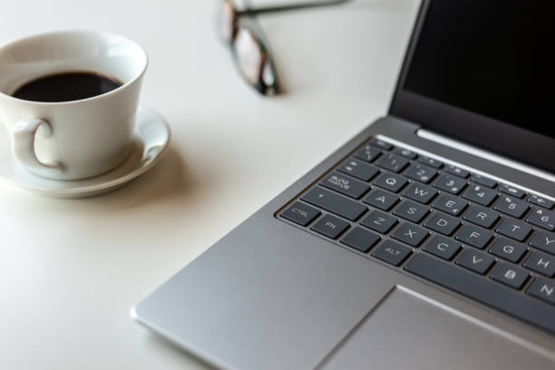 Close-up view of a laptop on a work desk.