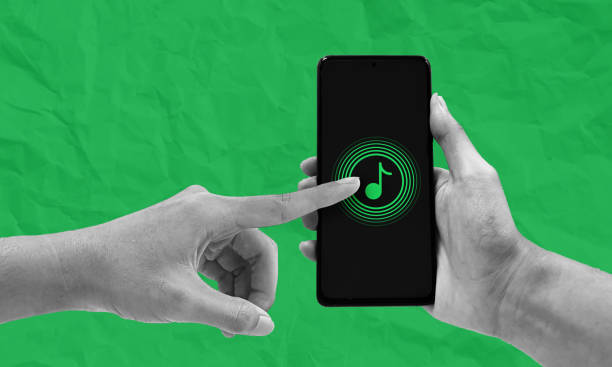 Hand interacting with music streaming service app on mobile phone. Listening to music anywhere concept, Isolated collage on green crumpled paper background.