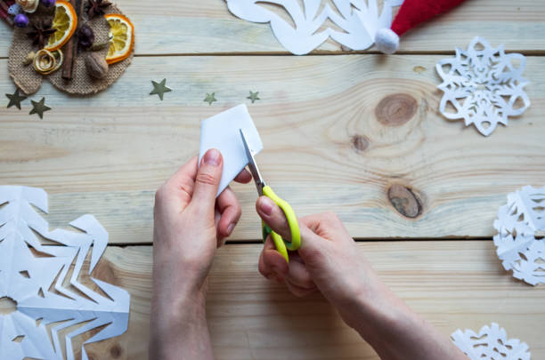 istock A snowflake made from paper with your own hands gracefully decorates a winter interior, adding warmth and a cozy atmosphere 2177849460