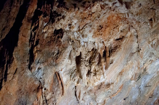 Close-up on the limestone formations formed over time in the depths of a cave in Piedmont
