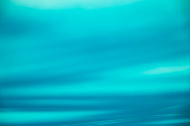 Underwater shot below the sea level with reflections of sun beams, waves and turquoise sea water. Best use for background.