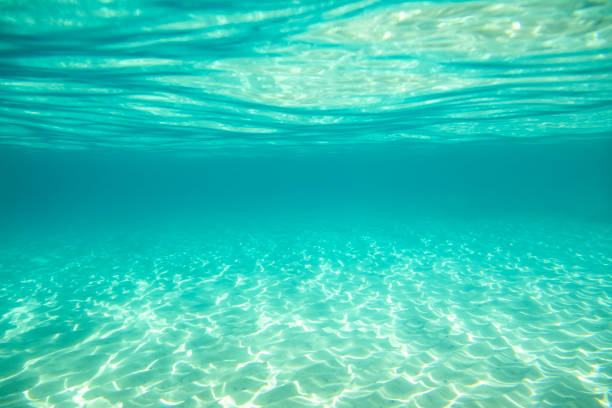 istock Underwater scene of turquoise blue sea, light reflections and sand 2177852434