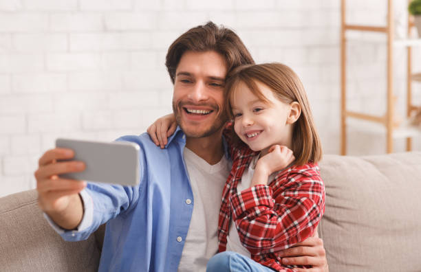 istock Father and daughter taking selfie on smartphone 2177853898