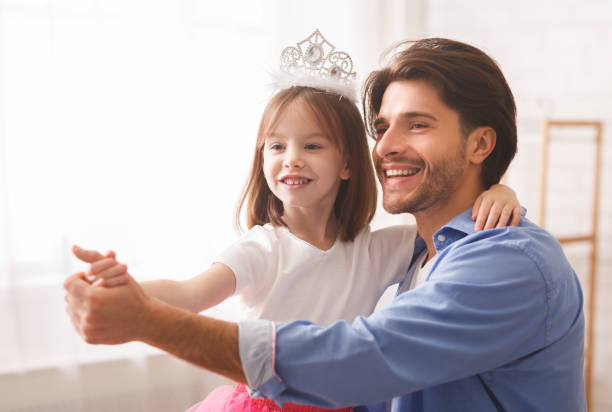 istock Little girl dancing tango with her father at home 2177853902