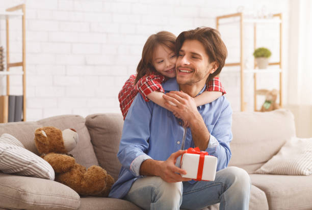 istock Cheerful little girl hugging her dad from behind 2177854051