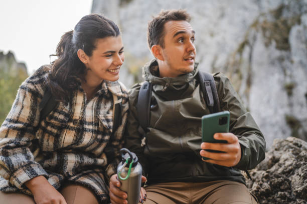 istock relax couple take a break from hiking and use mobile phone together 2177855926