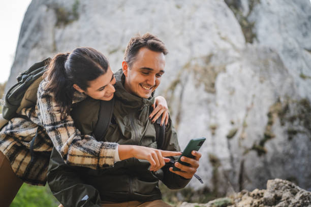 istock Girlfriend hug boyfriend while he use mobile phone on hiking 2177856715