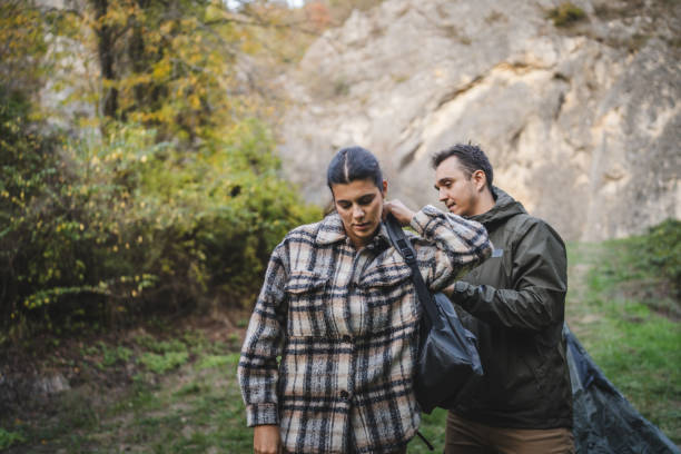 istock Boyfriend help girlfriend to pack and fasten her backpack 2177856980