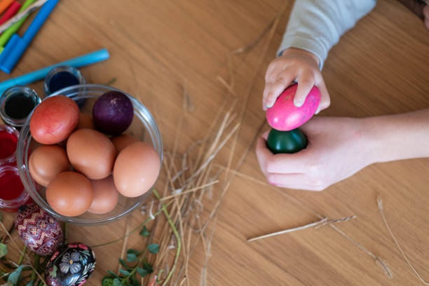 istock children's hands play with colorful Easter eggs 2177857106