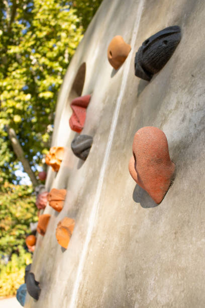 climbing holds on a concrete wall in a park