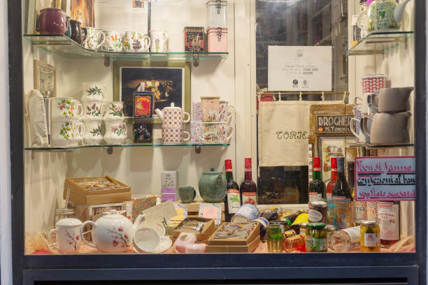 Genova, Italy, June 14, 2023: Exterior view looking through the glass of a gift shop window featuring tea pots and crockery