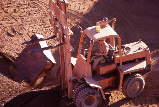 Tanami Desert, Northern Territory, Australia, January 7, 1987: View of a forklift working to move a piece of equipment at the bottom of an open cut gold mine pit in the Northern Territory