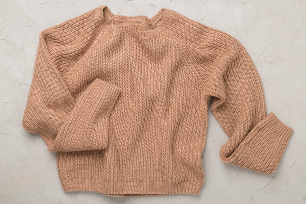 istock Brown sweater on concrete background, top view 2177859657