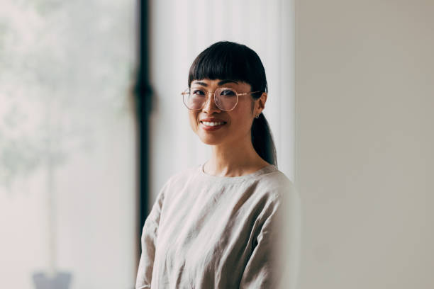 istock Smiling Woman in Glasses With Natural Light Background 2177864496