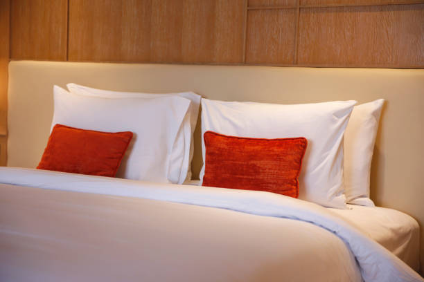 Close-up shot of Simplicity Modern Bedding Ideas for a Minimalist Bedroom.Concept: modern bedding, minimalist bedroom, simplicity design bed with headboard, bedding inspiration, cozy bedroom, modern decor, bedding trends, simple bedroom ideas, contemporary bedding, stylish bedroom setup