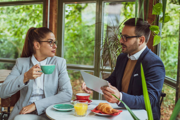 istock Two young, attractive, smartly dressed people having breakfast a 2177867528
