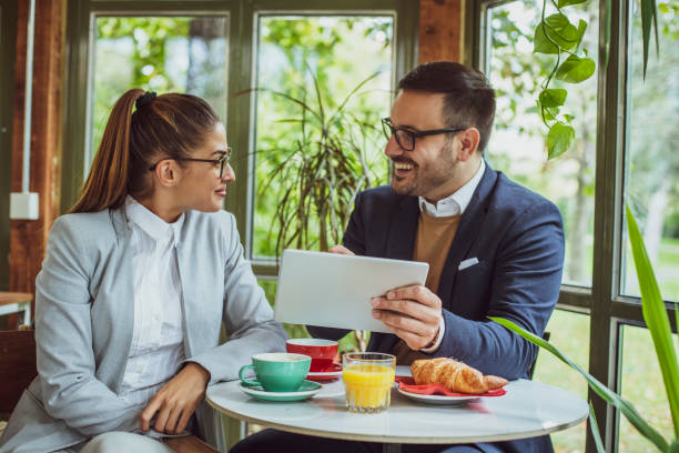 istock Two young, attractive, smartly dressed people having breakfast a 2177867530