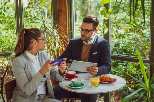 istock Two young, attractive, smartly dressed people having breakfast a 2177867531