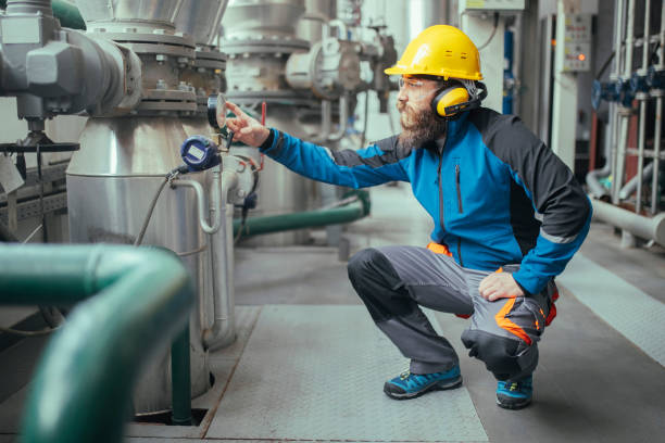 Side view of a focused heating plant worker.