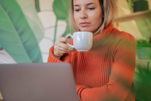 istock A beautiful, blonde woman uses a laptop while sitting in a resta 2177867652