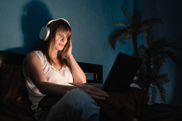 istock Woman using laptop watching movie suffering insomnia 2177874846