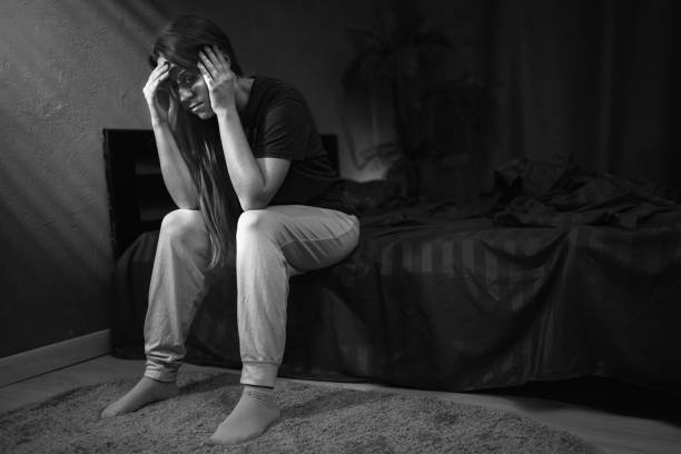 istock Depressed woman suffering from headache at night 2177874927